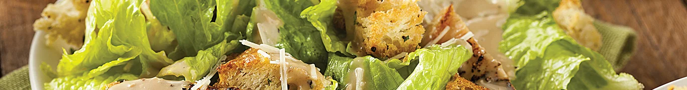 Caesar salad on a white plate.