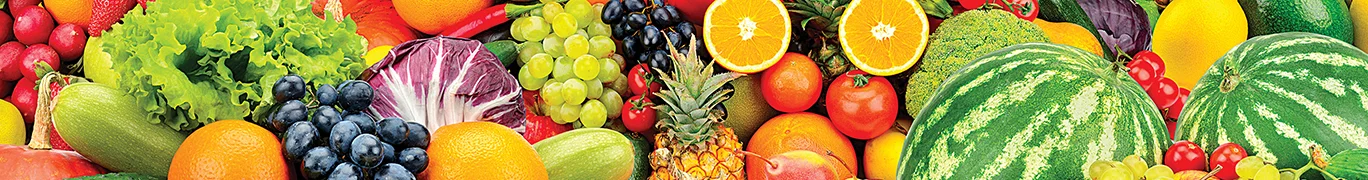 An assortment of fruits and vegetables including watermelon, sliced oranges, cherry and more